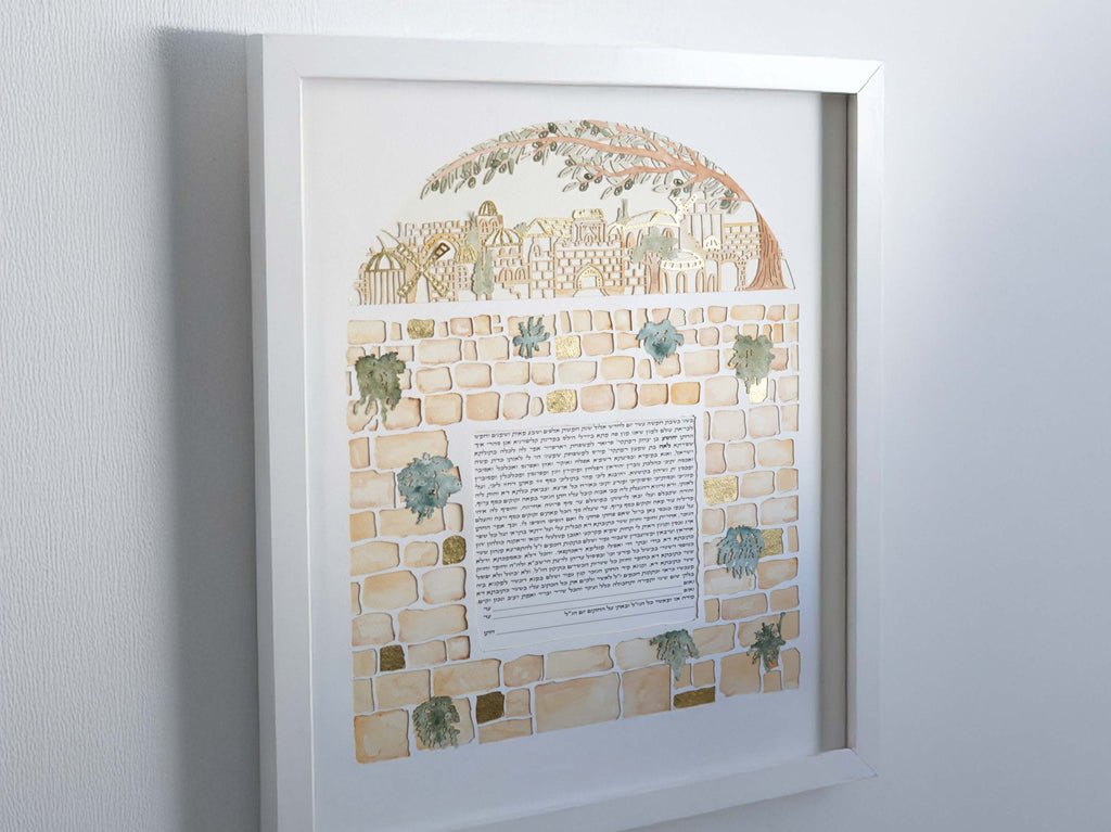 “Kotel Stones that Hear” Papercut and watercolor ketubah featuring gold foil accents.